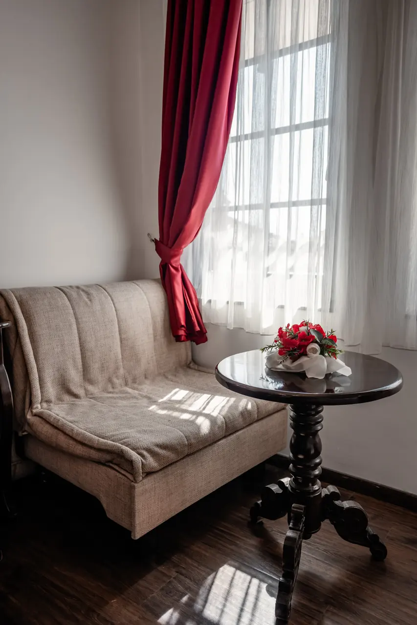 Window seat with round table and flowers, portrait